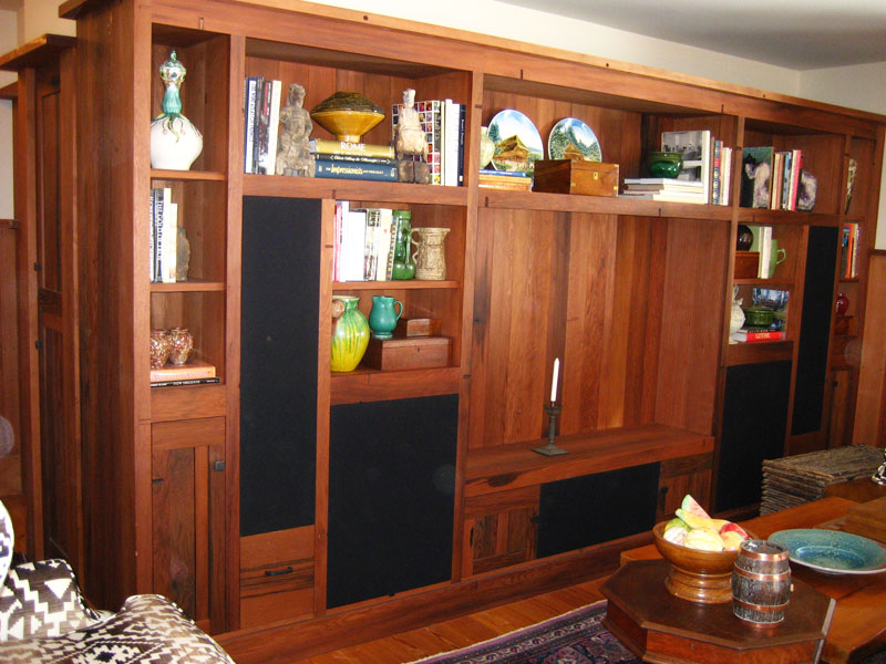 Custom reclaimed wine vat wood entertainment unit . with paneled end,slat doors , fabric insets